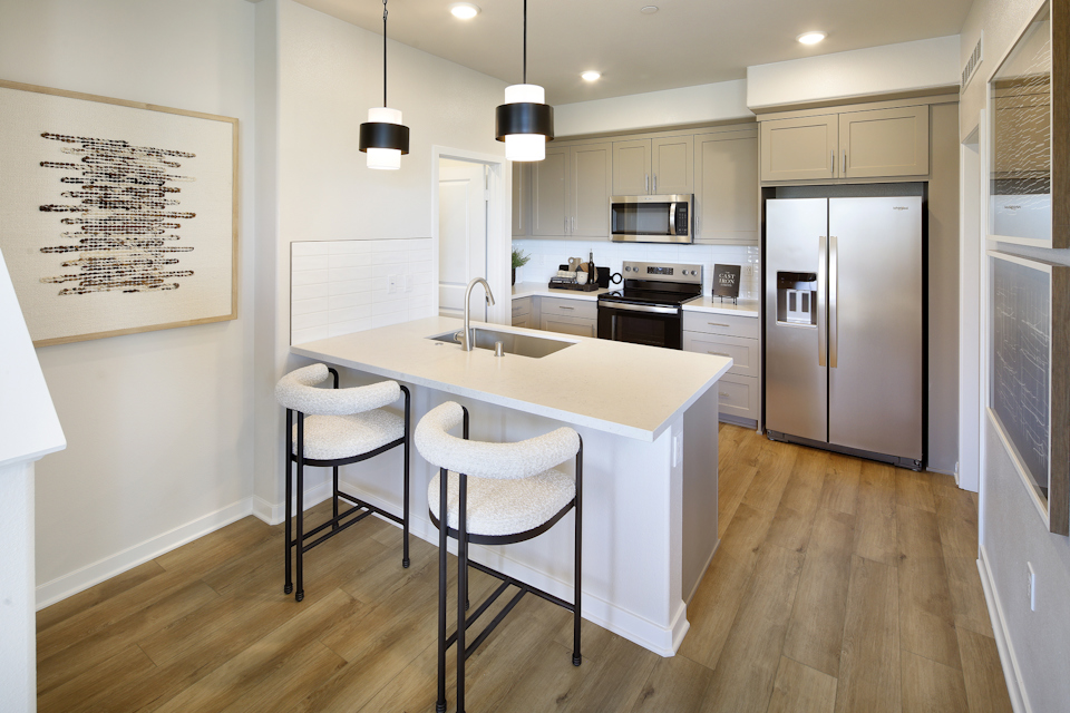 A kitchen with a table and chairs.