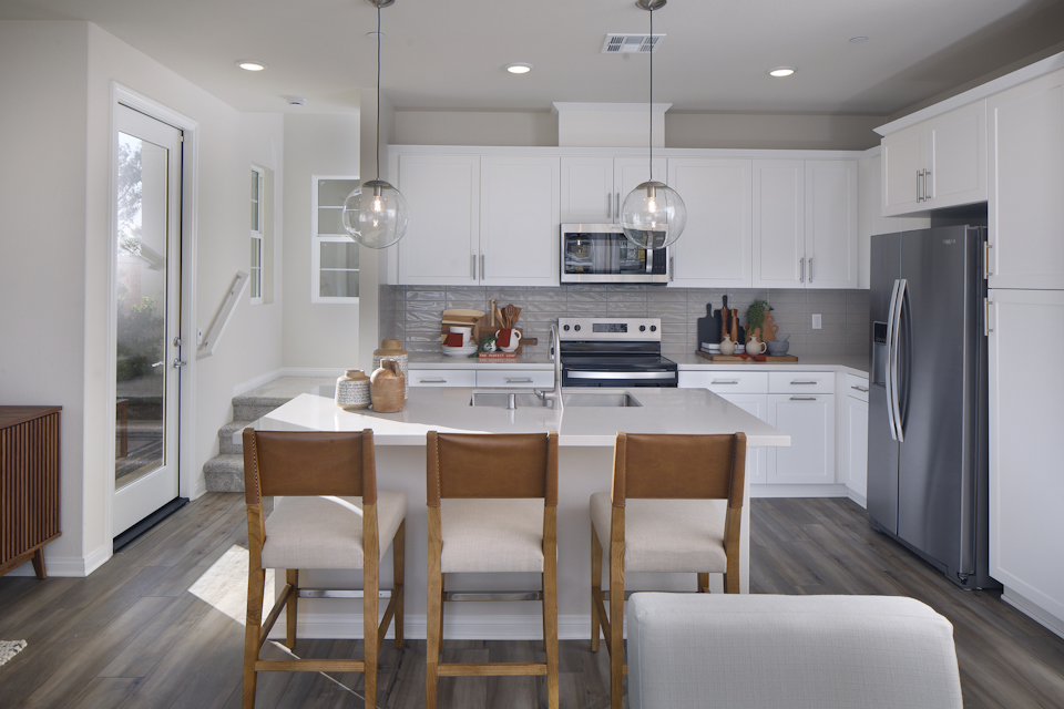 A kitchen with white cabinets.