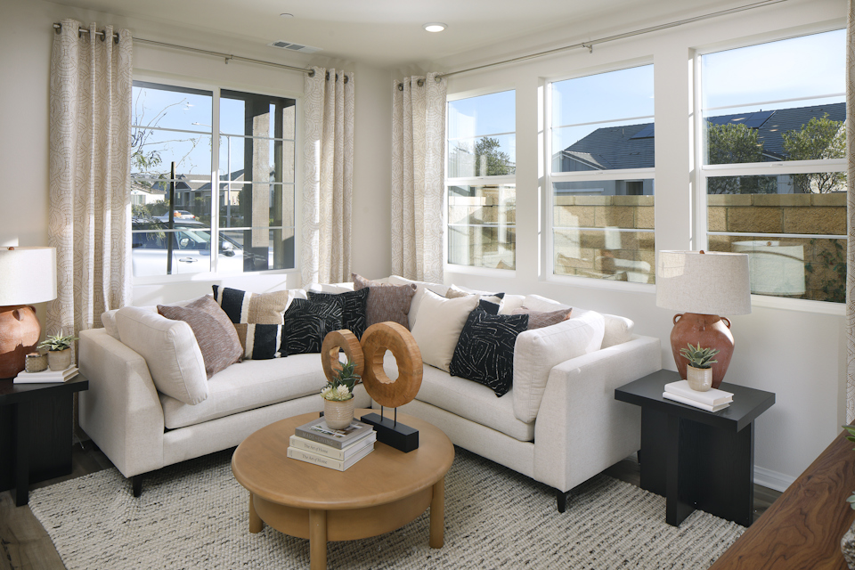 A living room with a white couch and a coffee table.