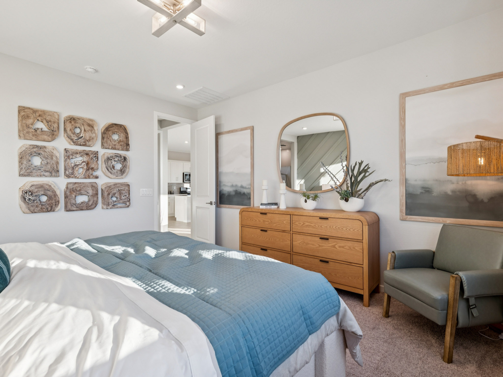 A bedroom with a bed and a mirror.