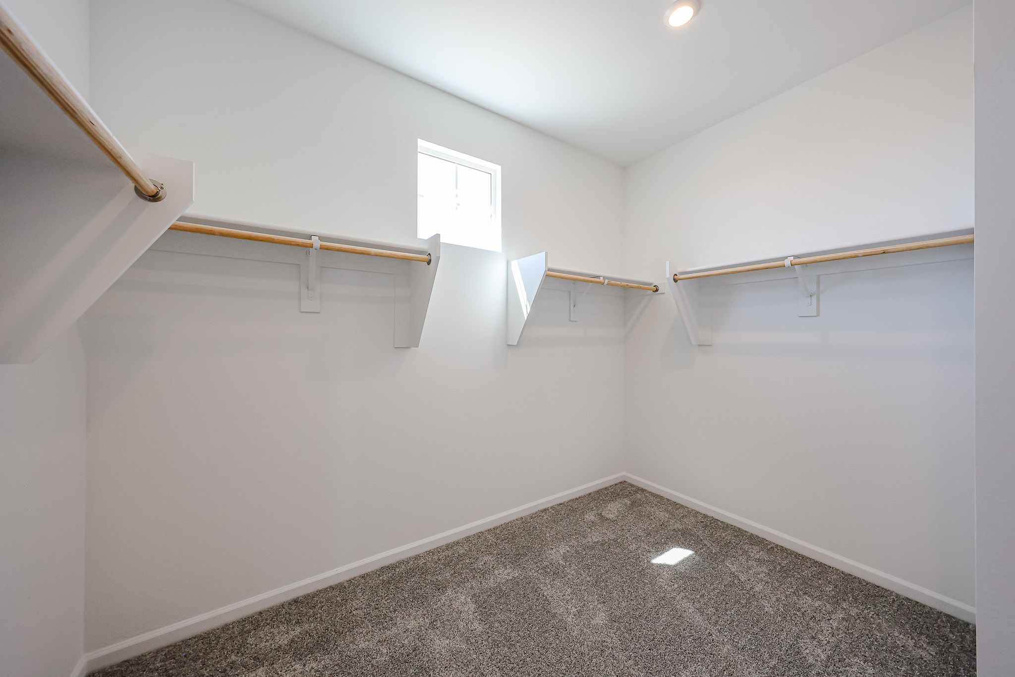 A white room with a black carpet.