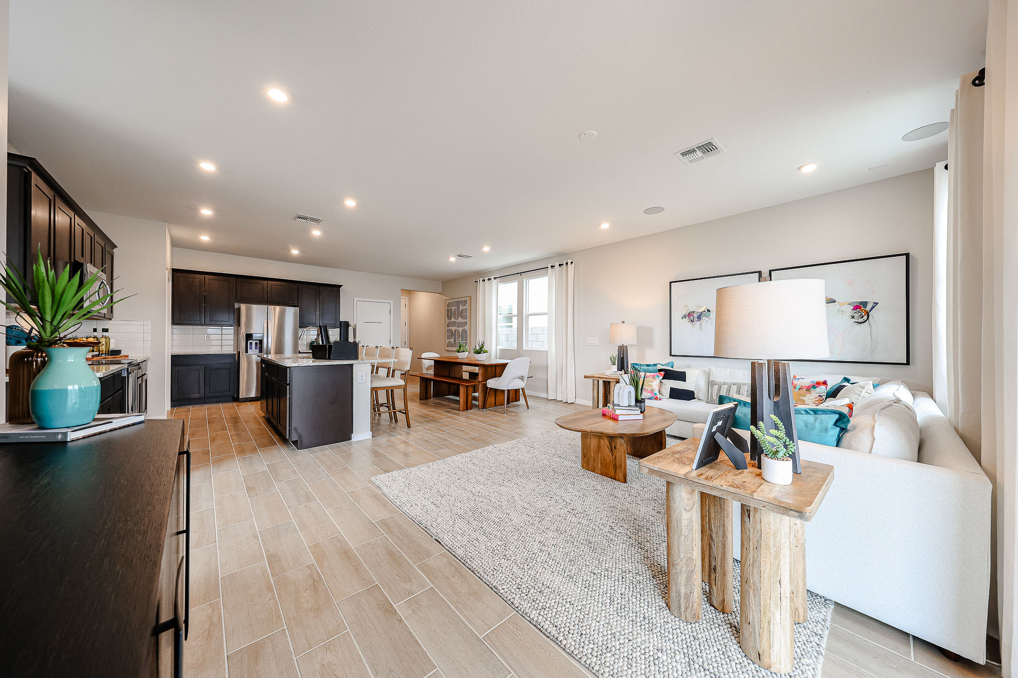 A large living room with a wood floor and white walls.