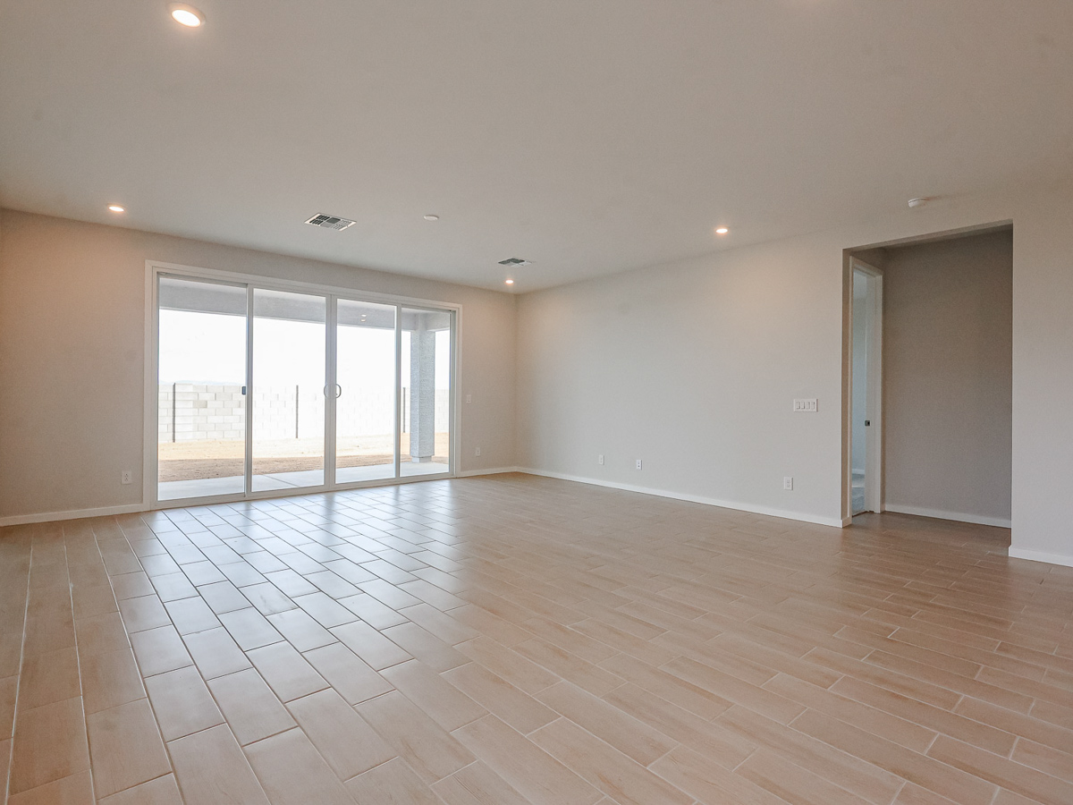 A room with a tile floor and a wood floor.
