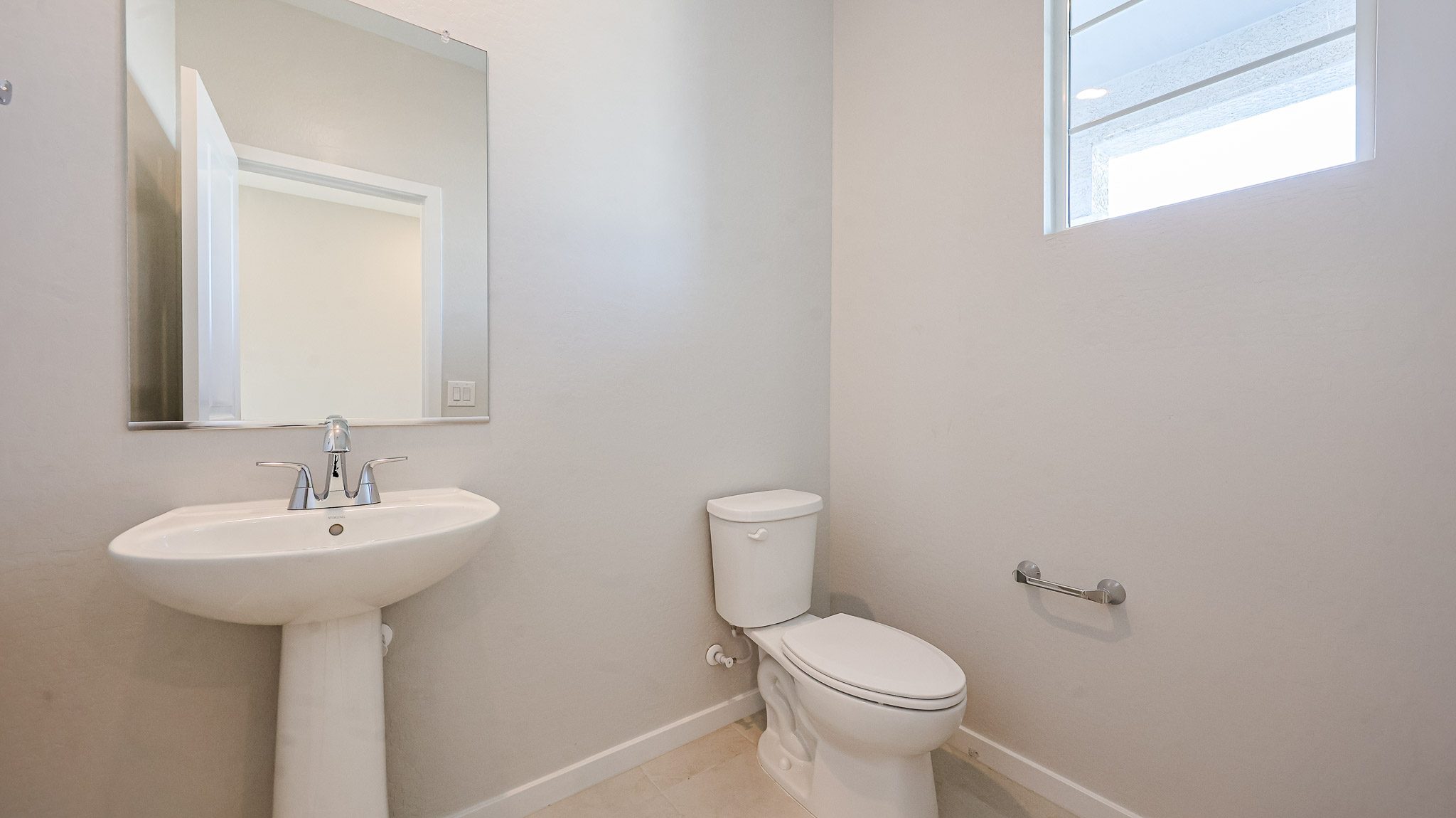 A bathroom with a toilet and sink.