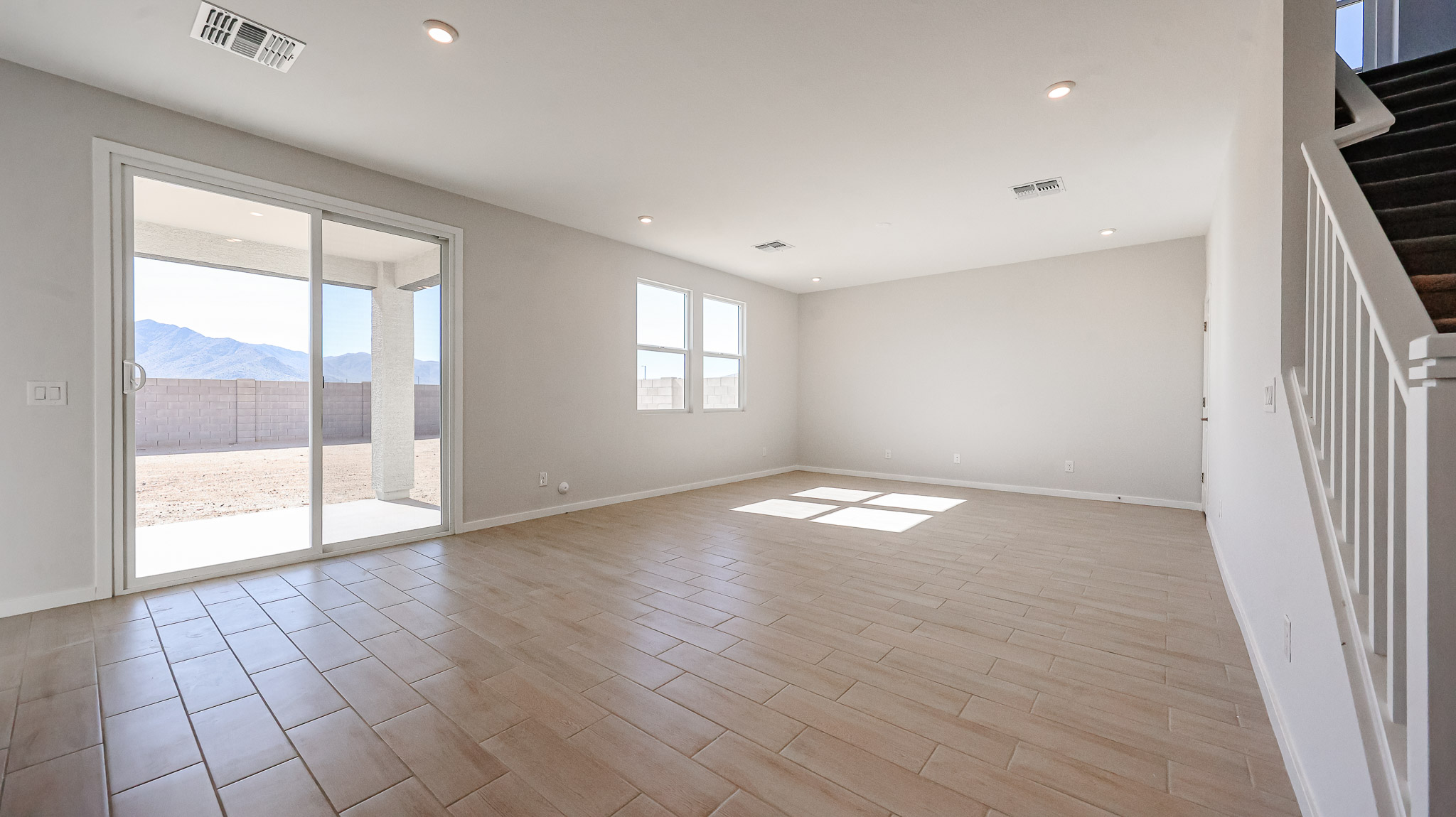 A room with a wood floor and a wood floor with a window.