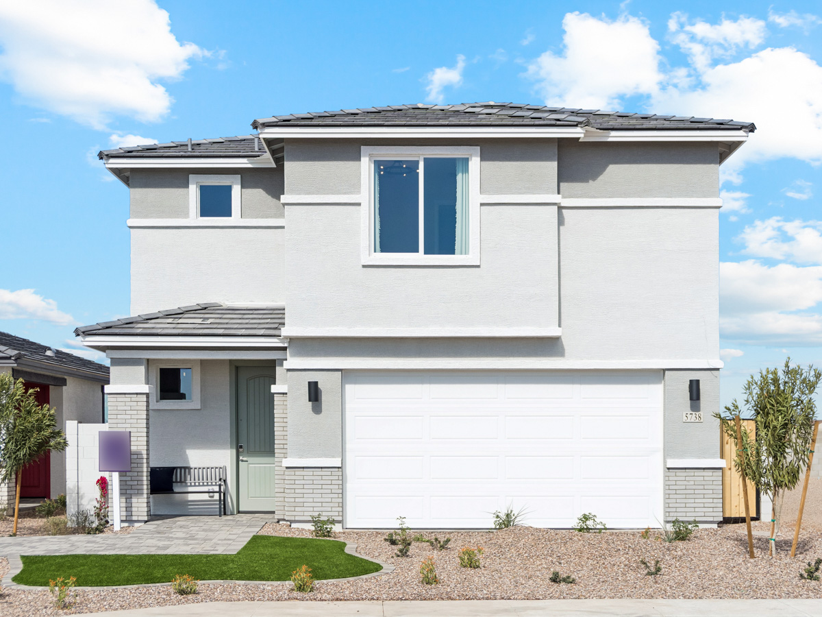 A white house with a garage.