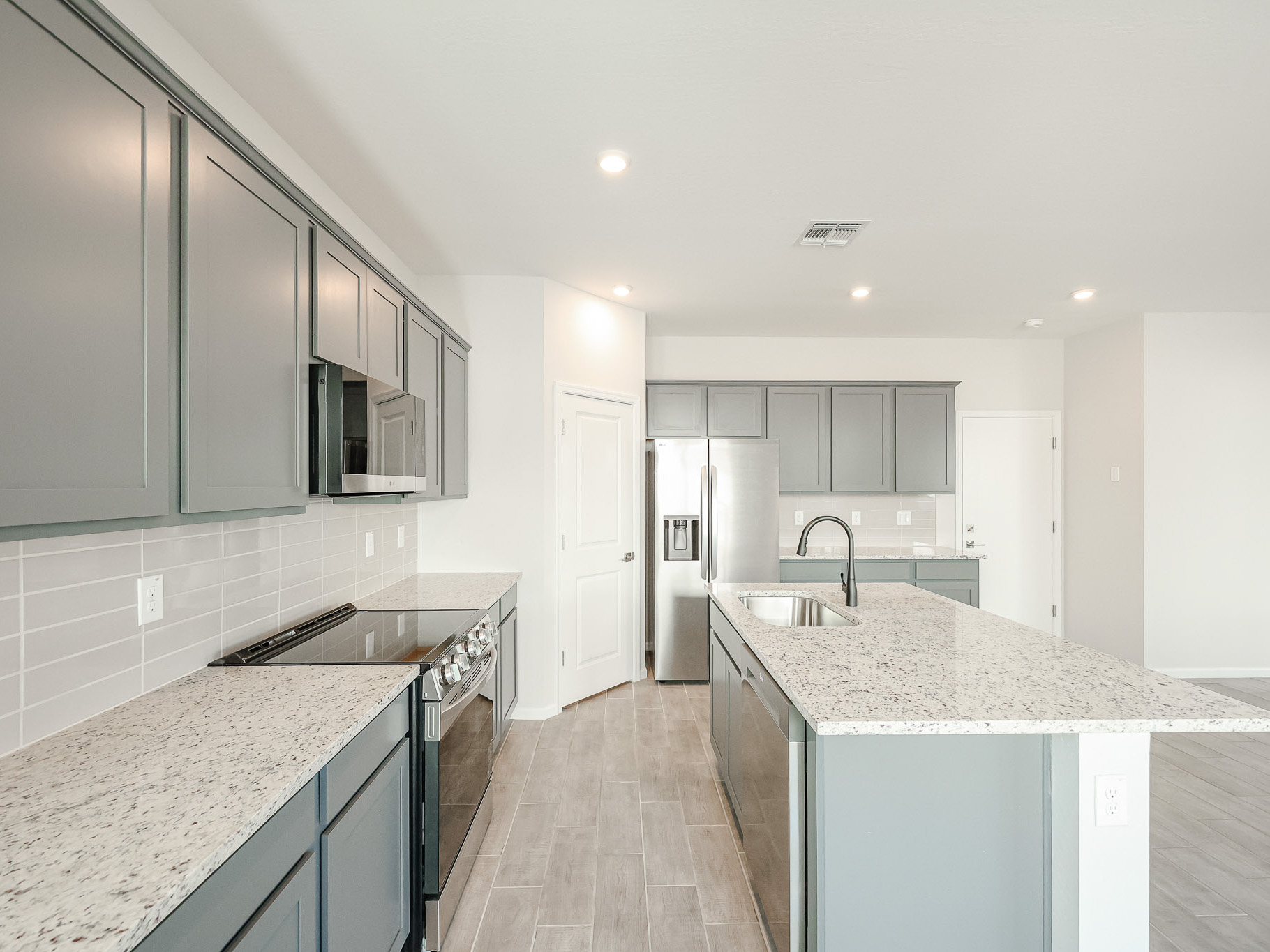 A kitchen with black cabinets.