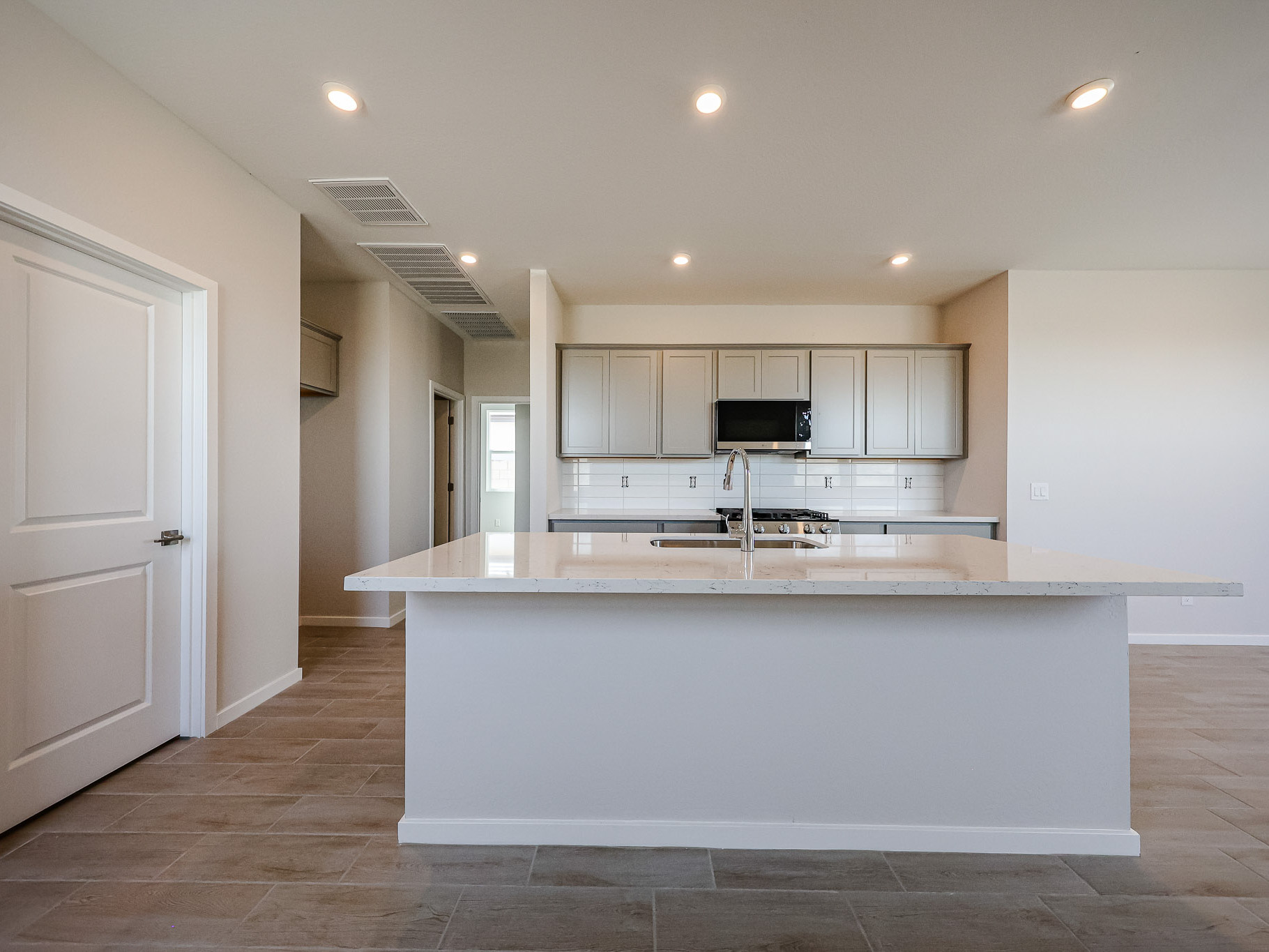 A kitchen with white cabinets.
