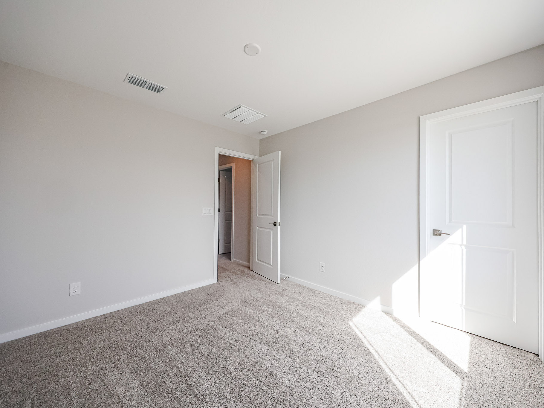 A hallway with white doors.