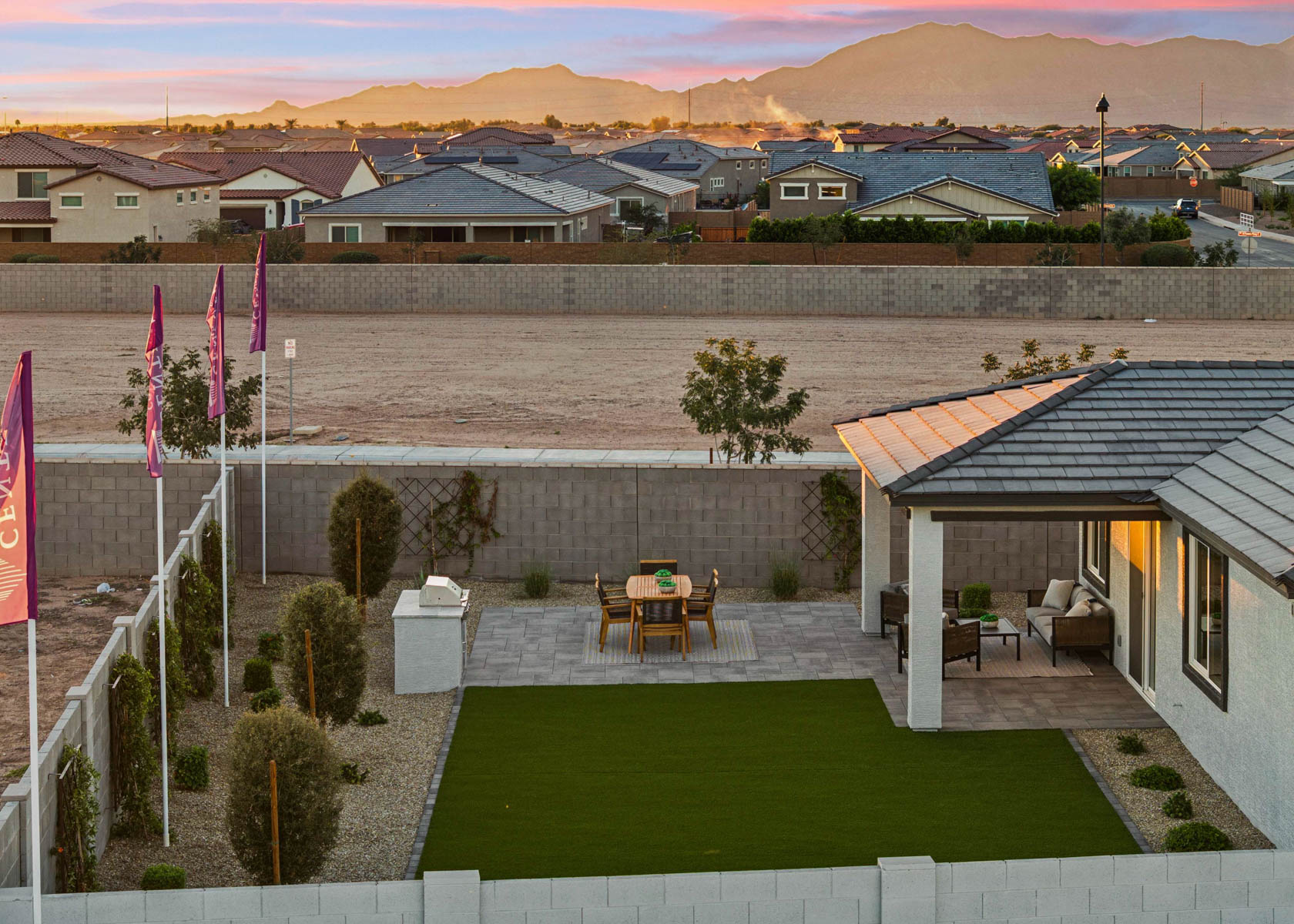A backyard with a table and chairs.