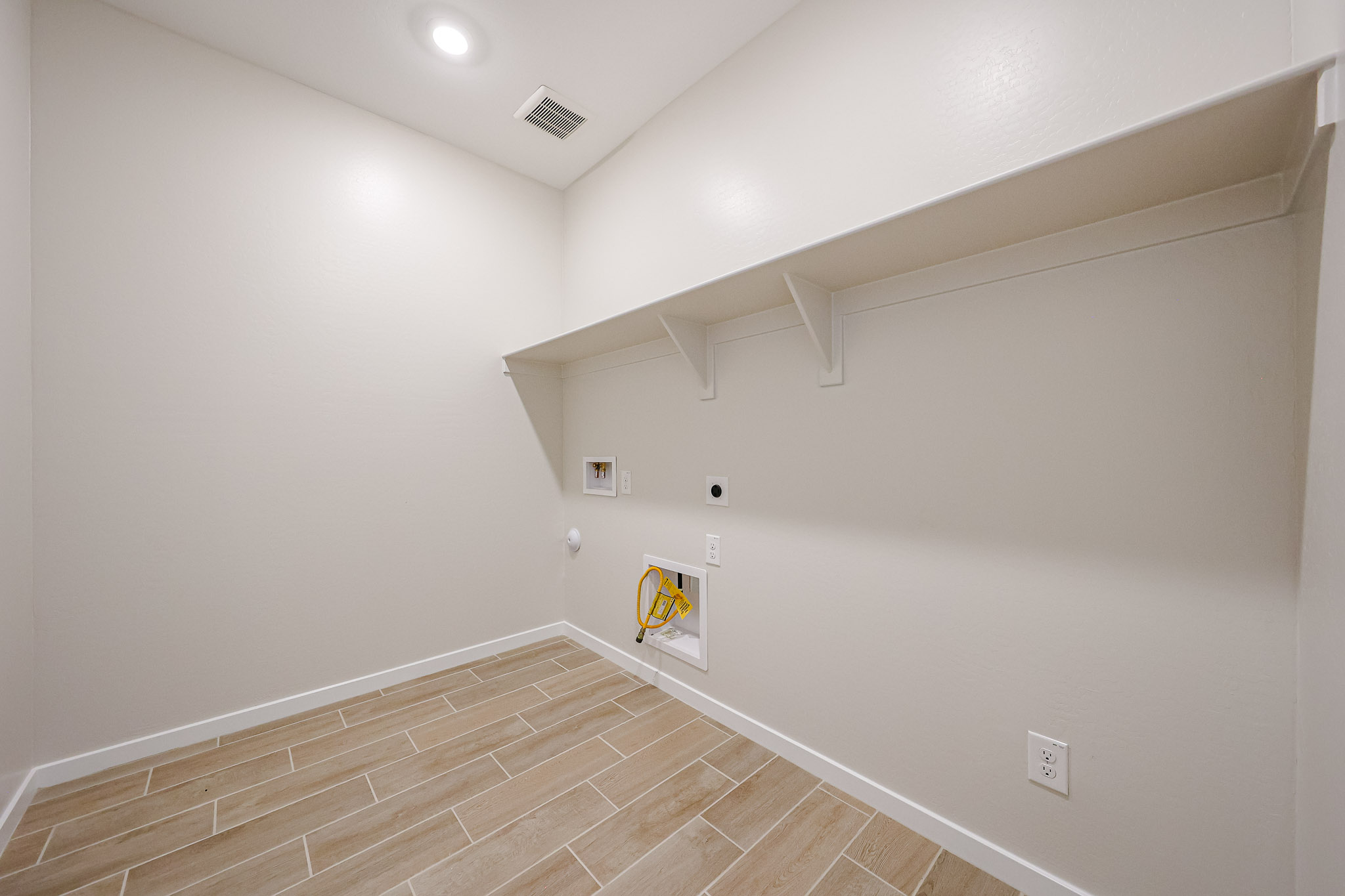 A room with a wood floor and white walls.