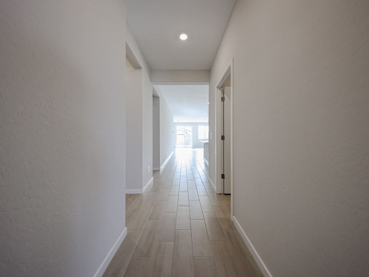 A long hallway with white walls.