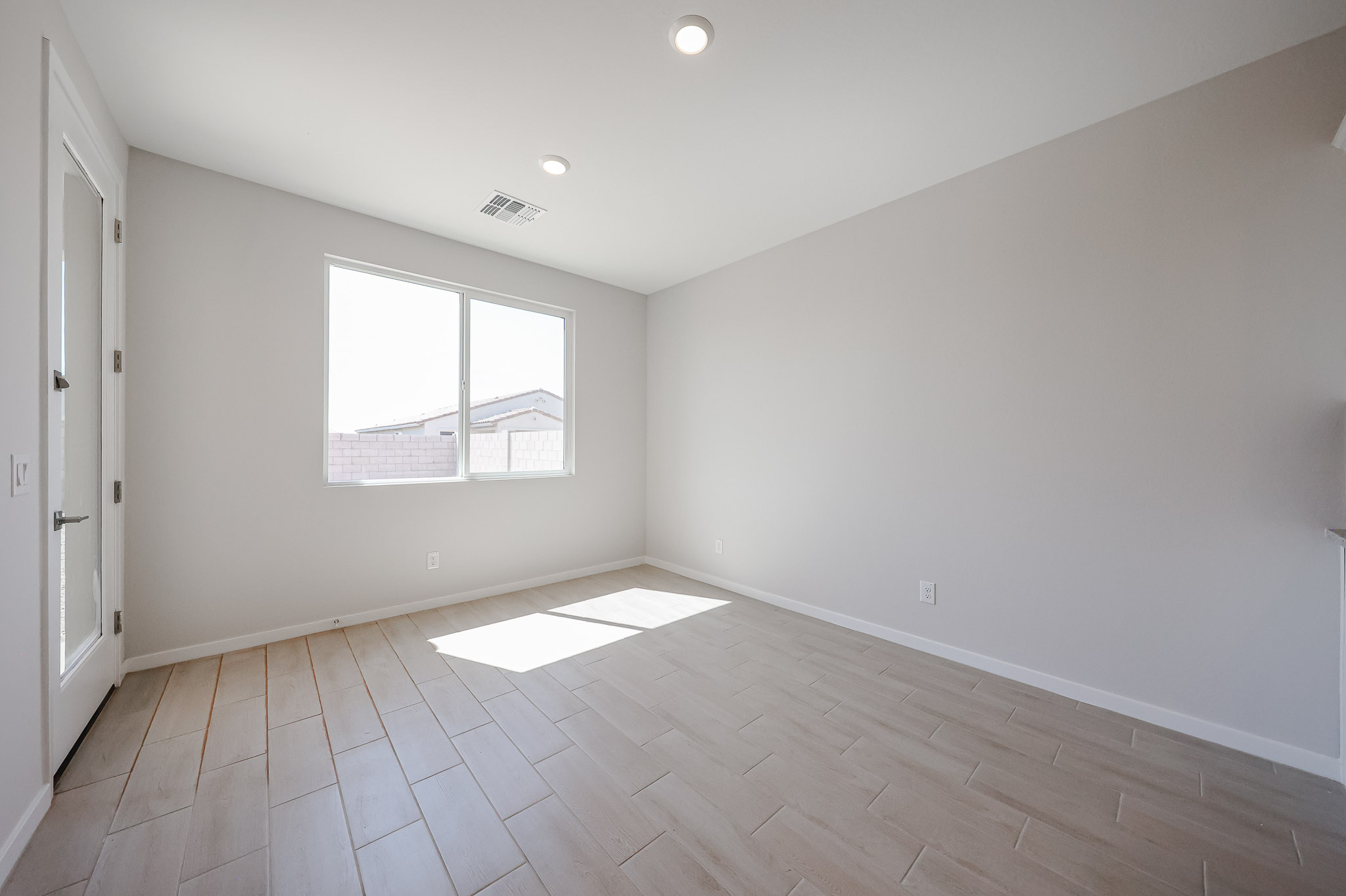 A room with a tile floor and a window.