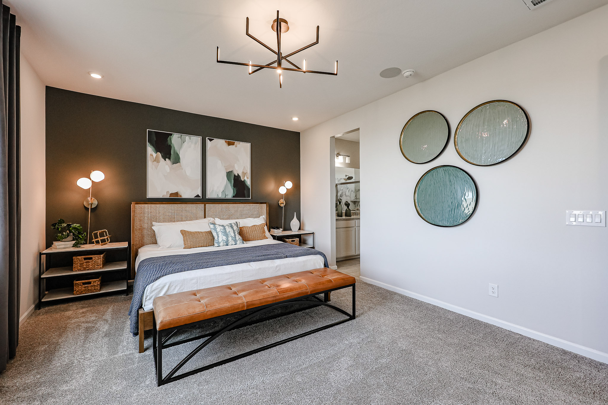 A bedroom with a bed and a mirror.