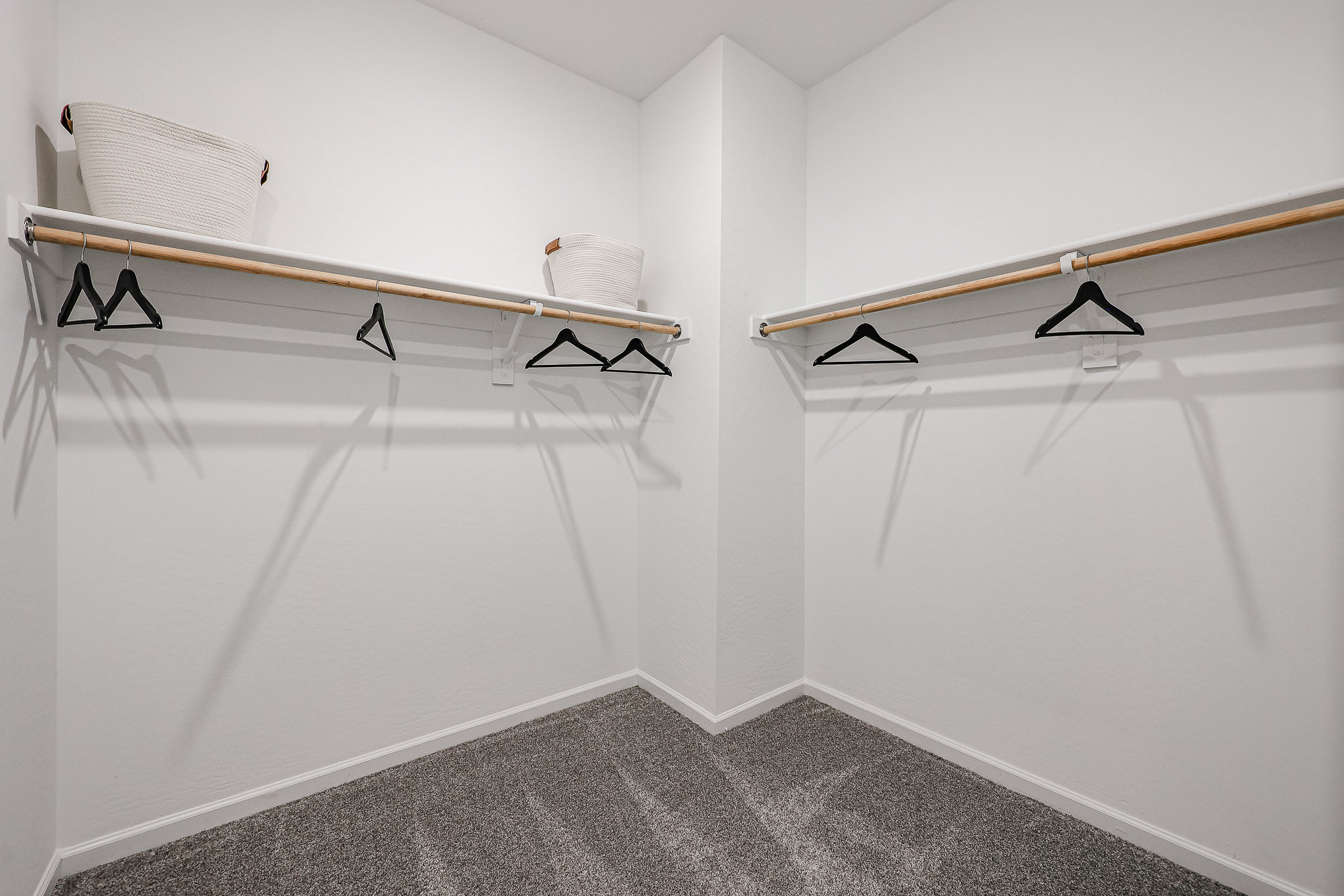 A white room with a bed and a chair.