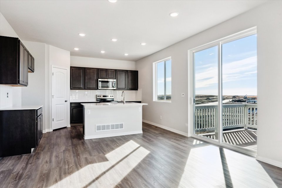 A kitchen with a large glass door.
