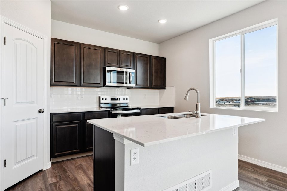 A kitchen with black cabinets.