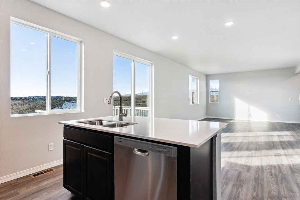 A kitchen with a sink and a window.