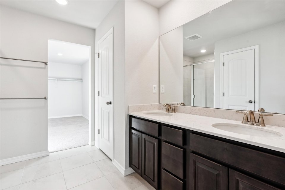 A bathroom with a large mirror.