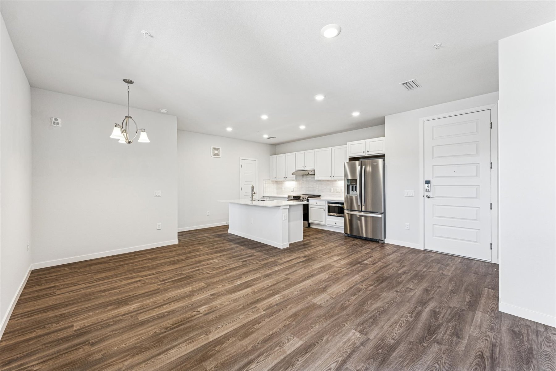 A large kitchen with white cabinets.