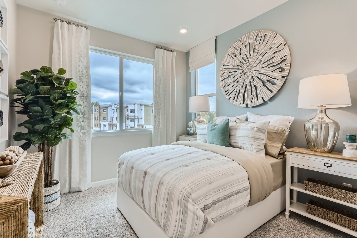 A bedroom with a large window.