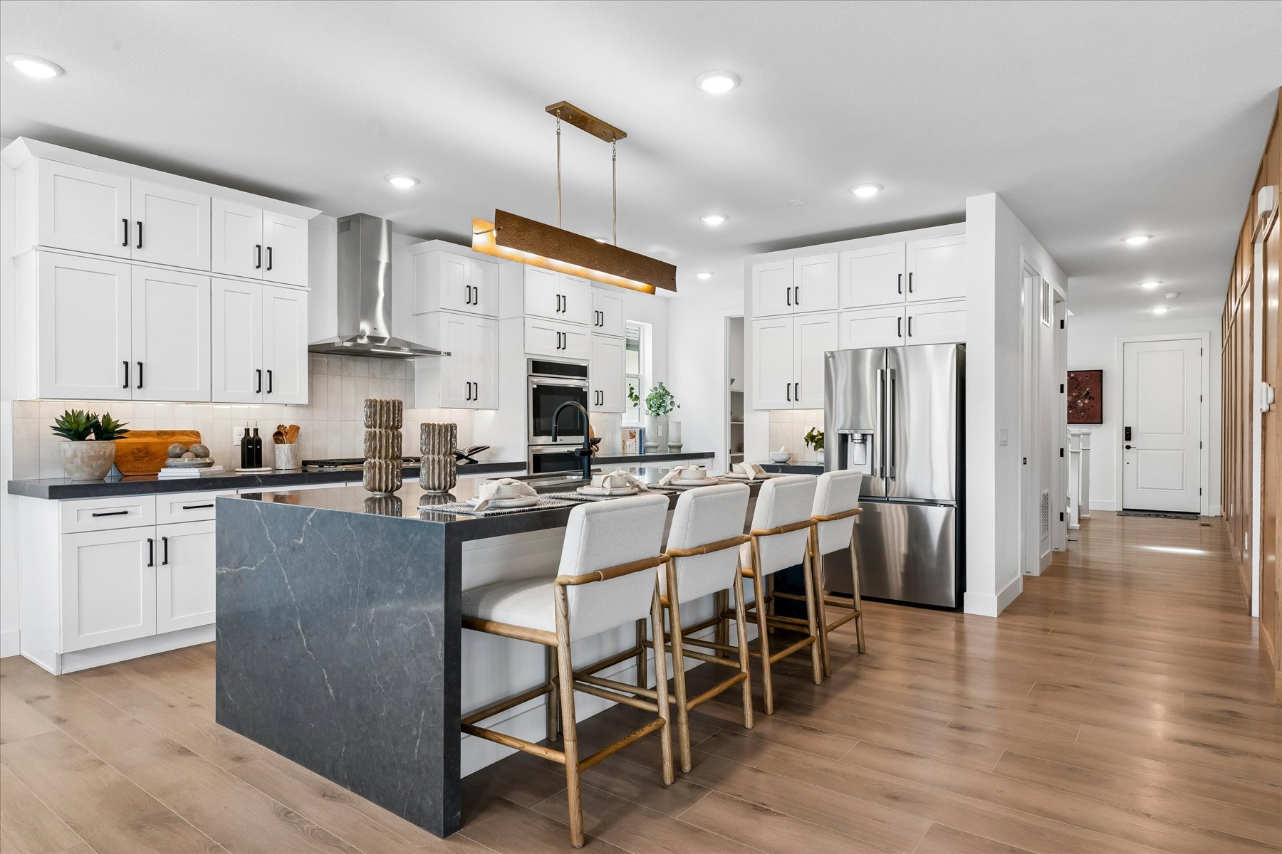 A kitchen with white cabinets.