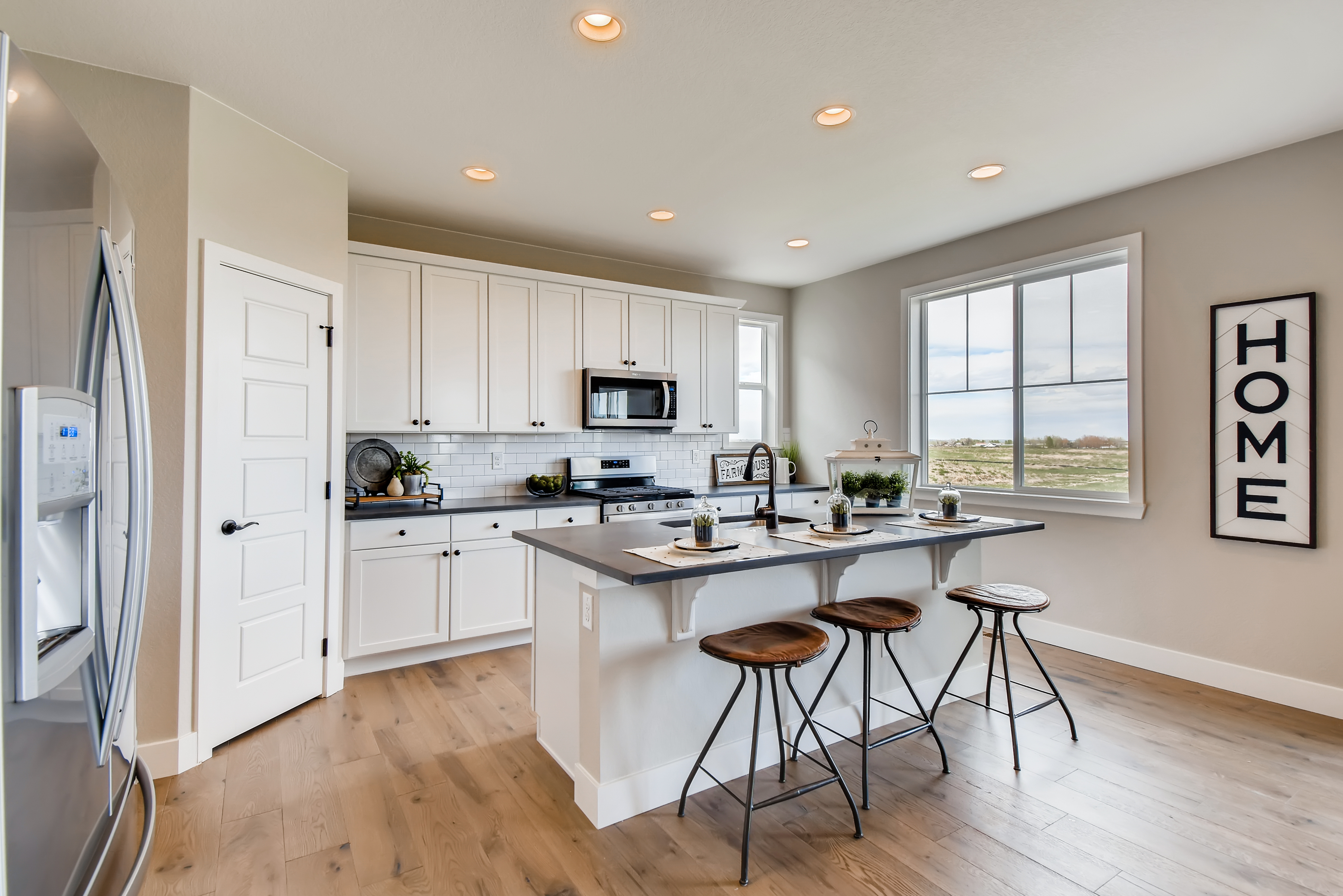 A kitchen with stools and a table.