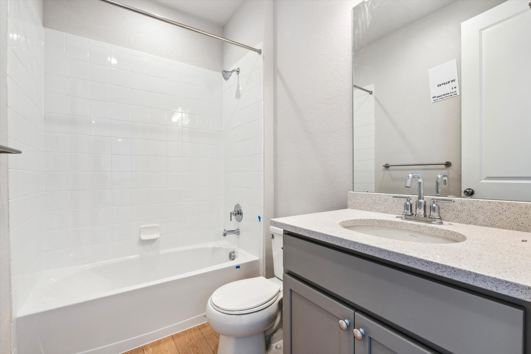 A bathroom with a tub sink and toilet.