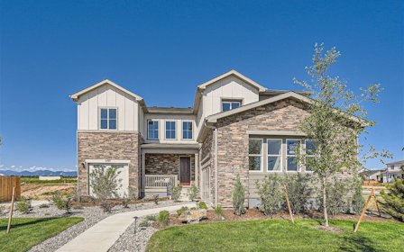 A house with a yard and a tree in front of it.