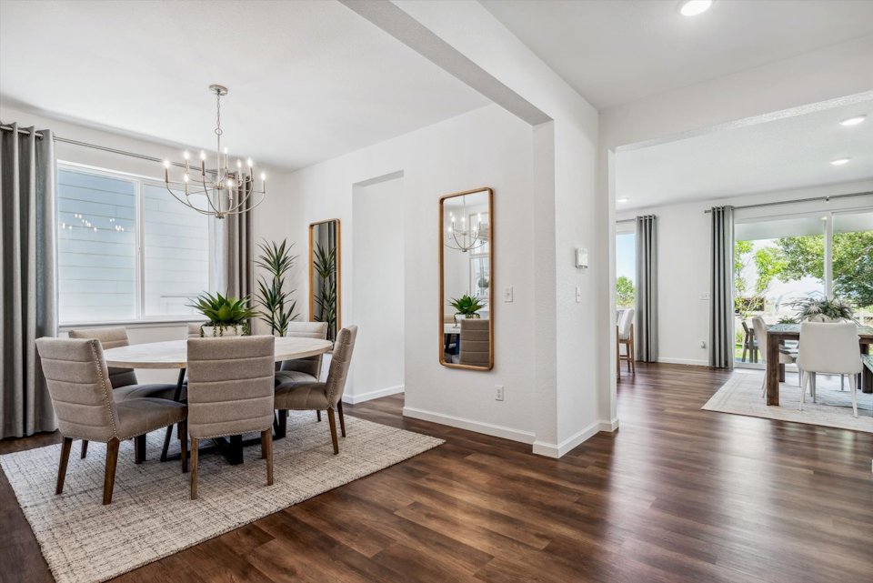 A dining room with a wood floor.