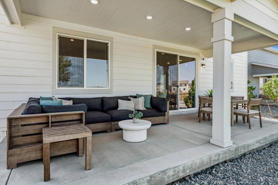 A living room with a couch and chairs.