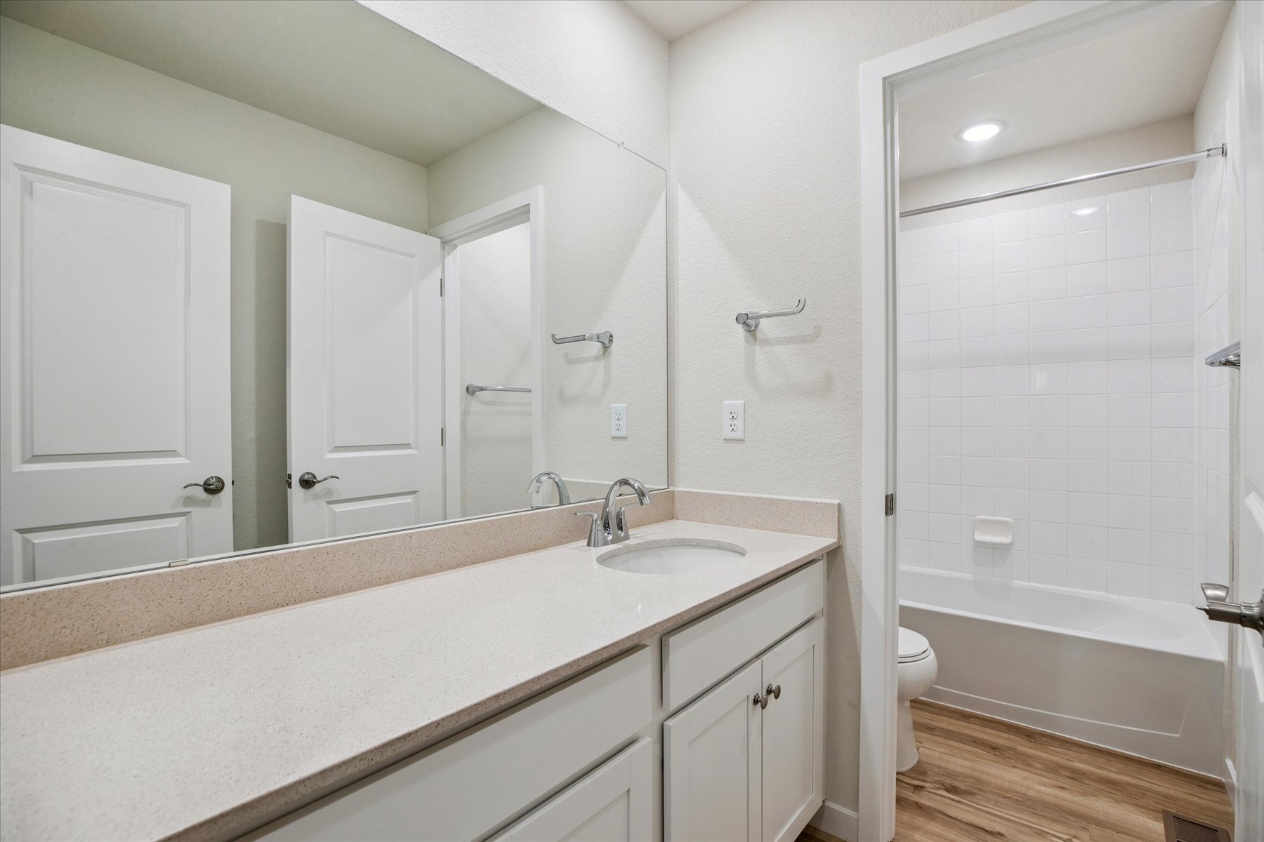 A bathroom with a tub sink and toilet.
