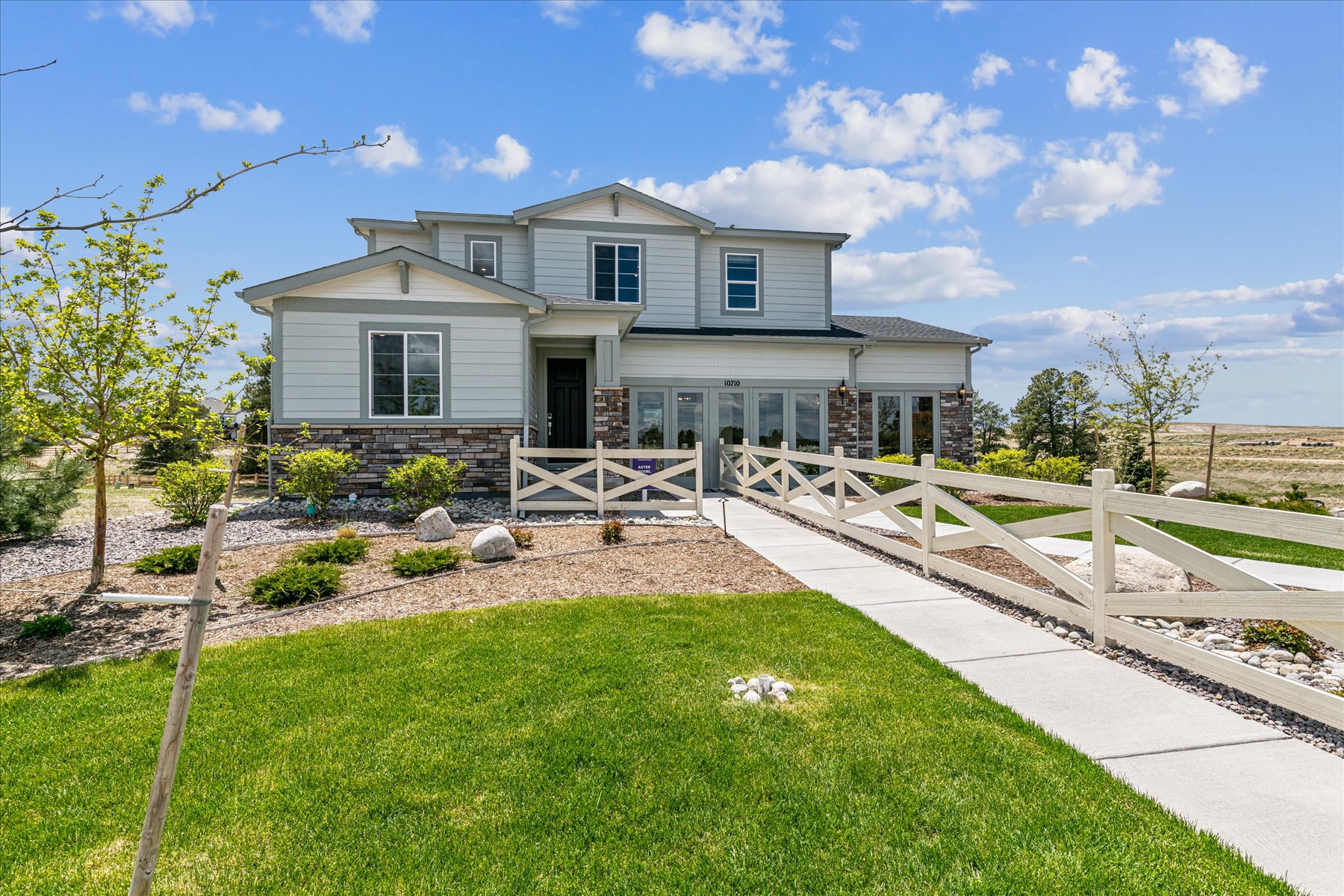 A house with a fence and grass.