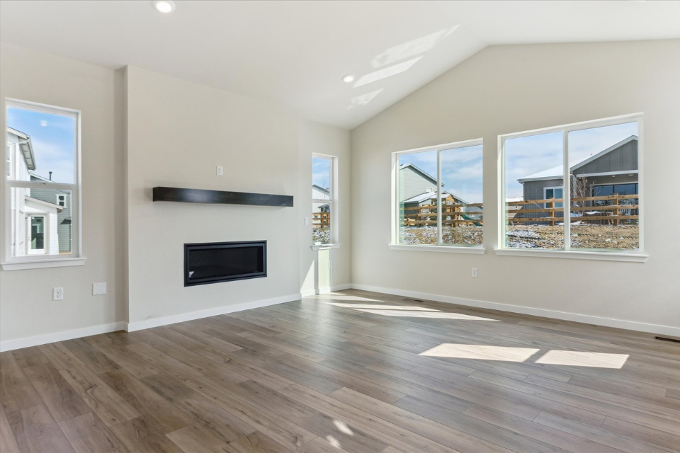 A room with a fireplace and windows.