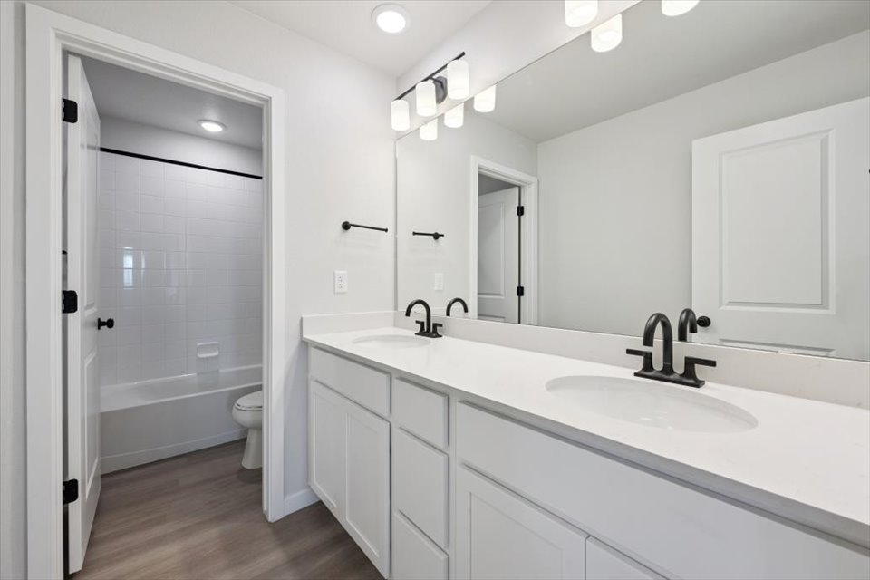 A bathroom with a sink and a shower unit.