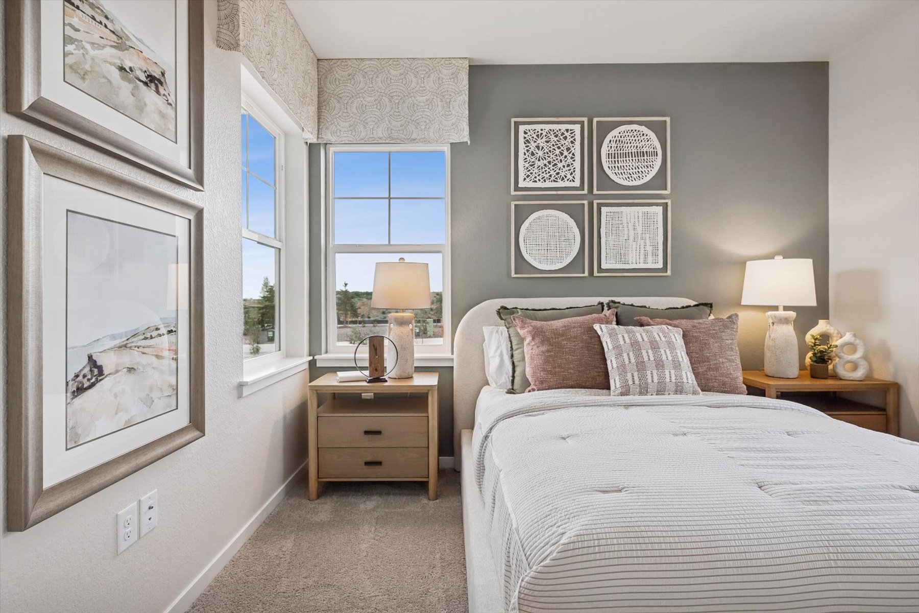 A bedroom with a bed and lamps.