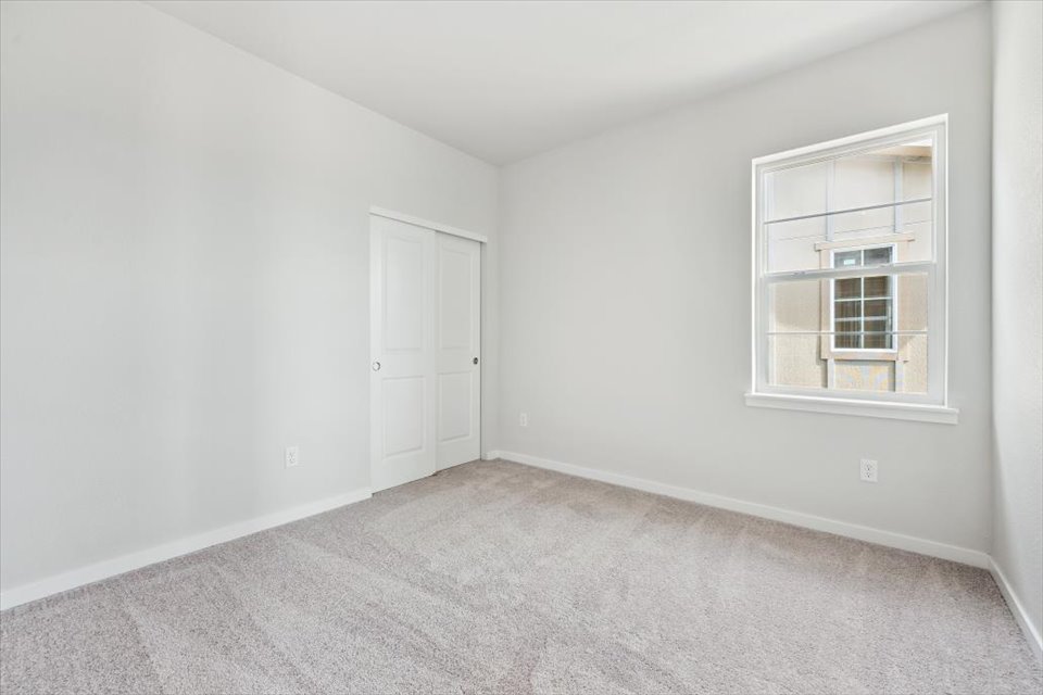A room with white walls and a window.