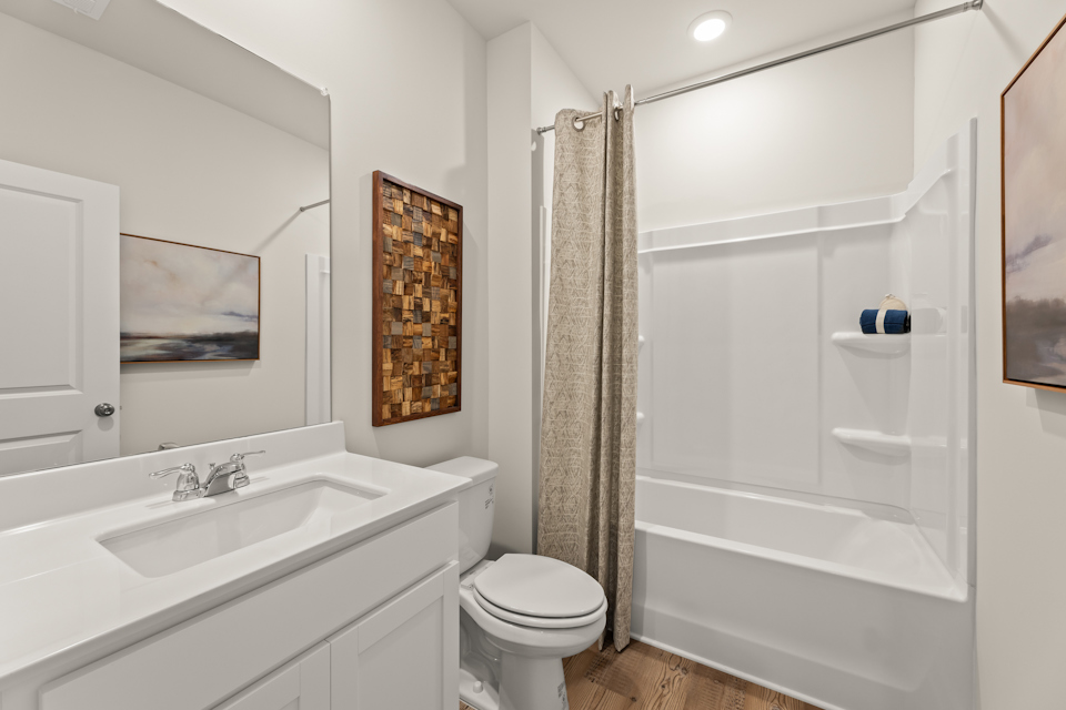 A bathroom with a shower and sink.