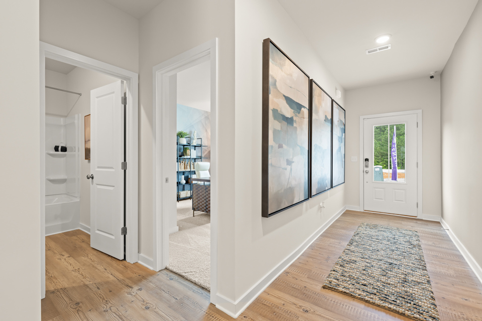 A room with white walls and a rug.