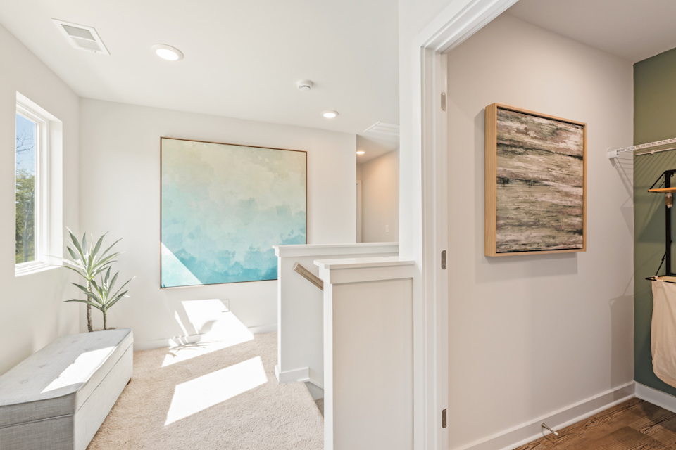 A room with a painting on the wall.