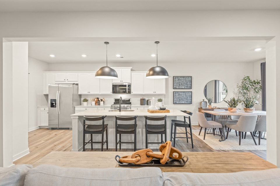 A kitchen with a table and chairs.