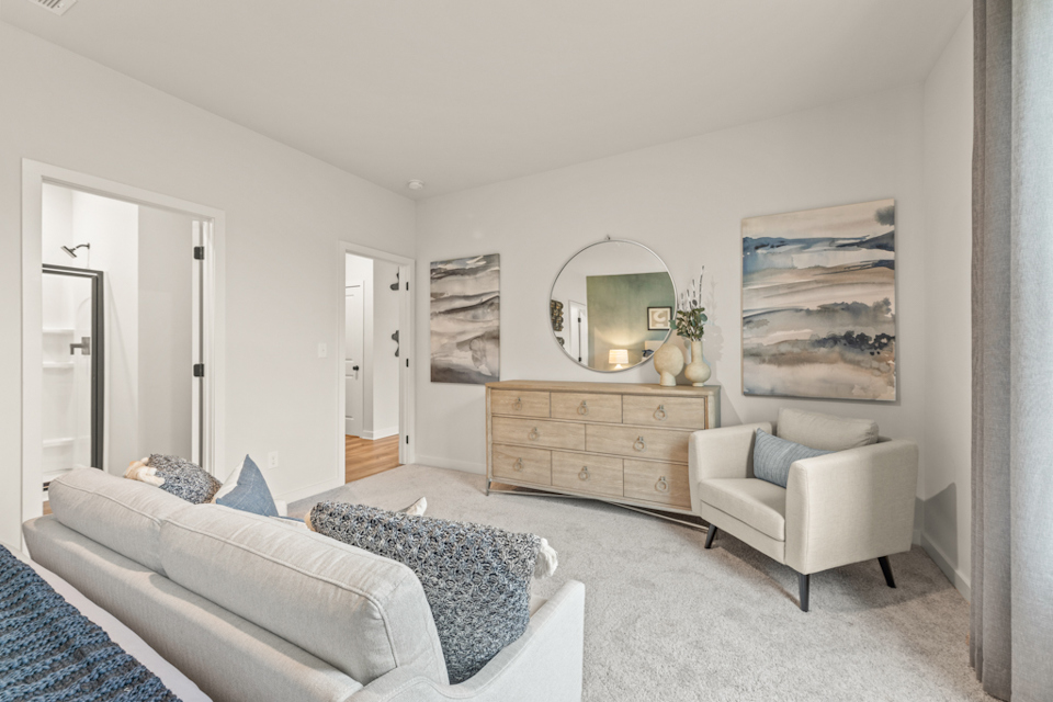 A living room with a couch and a mirror.