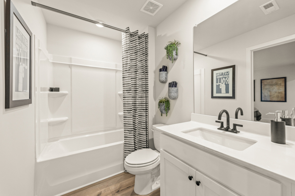 A bathroom with a tub sink and toilet.