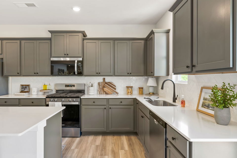 A kitchen with white cabinets.