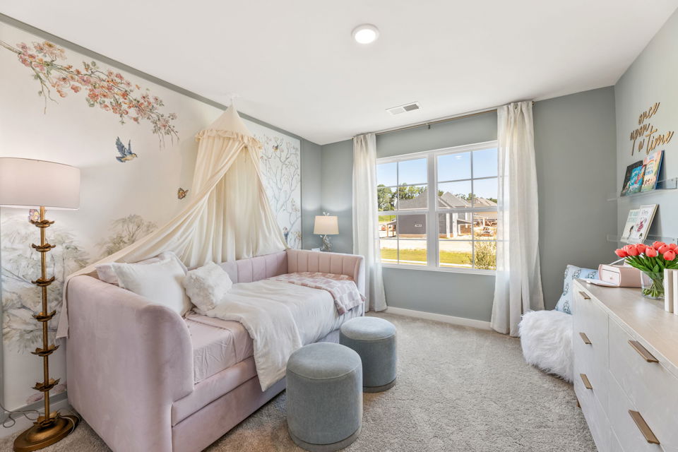 A bedroom with a bed and a couch.