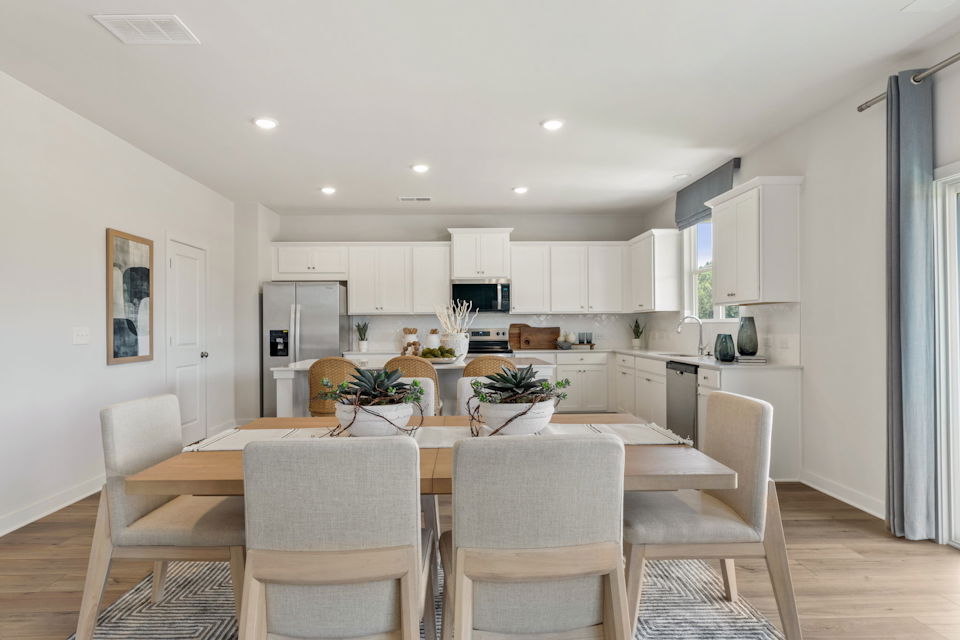 A kitchen with a dining table.