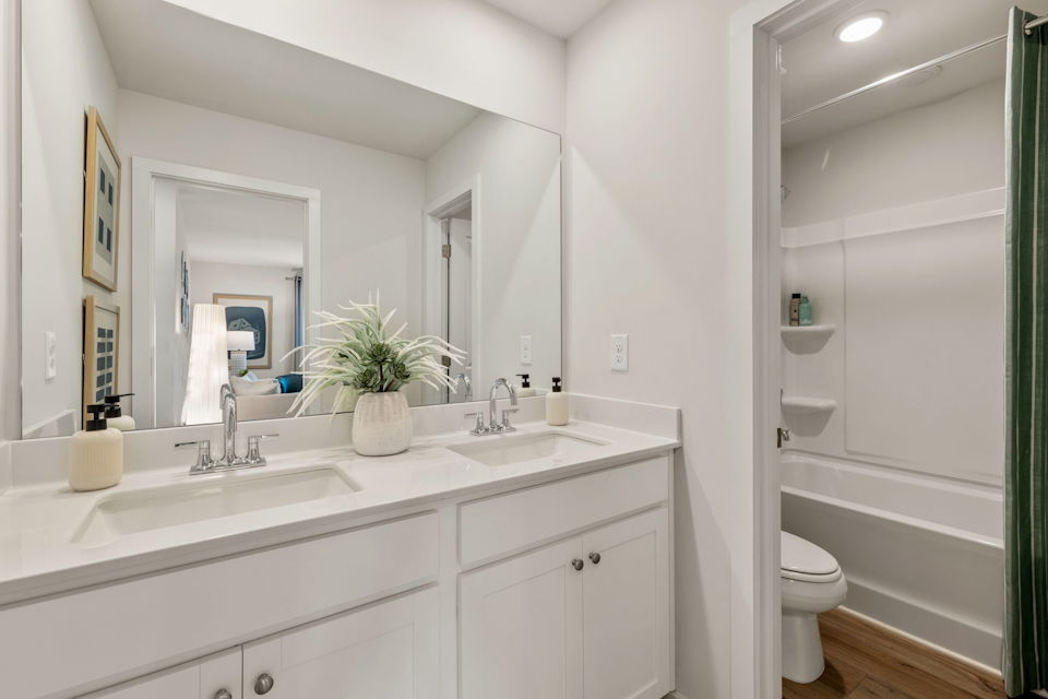 A bathroom with a tub sink and toilet.
