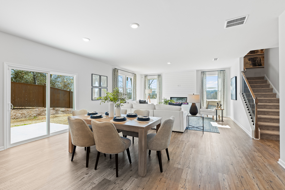 A dining room with a wood floor.