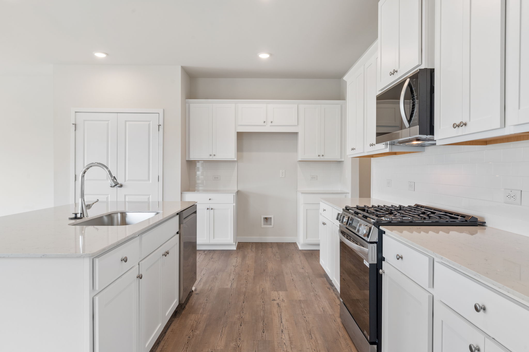 A kitchen with white cabinets.