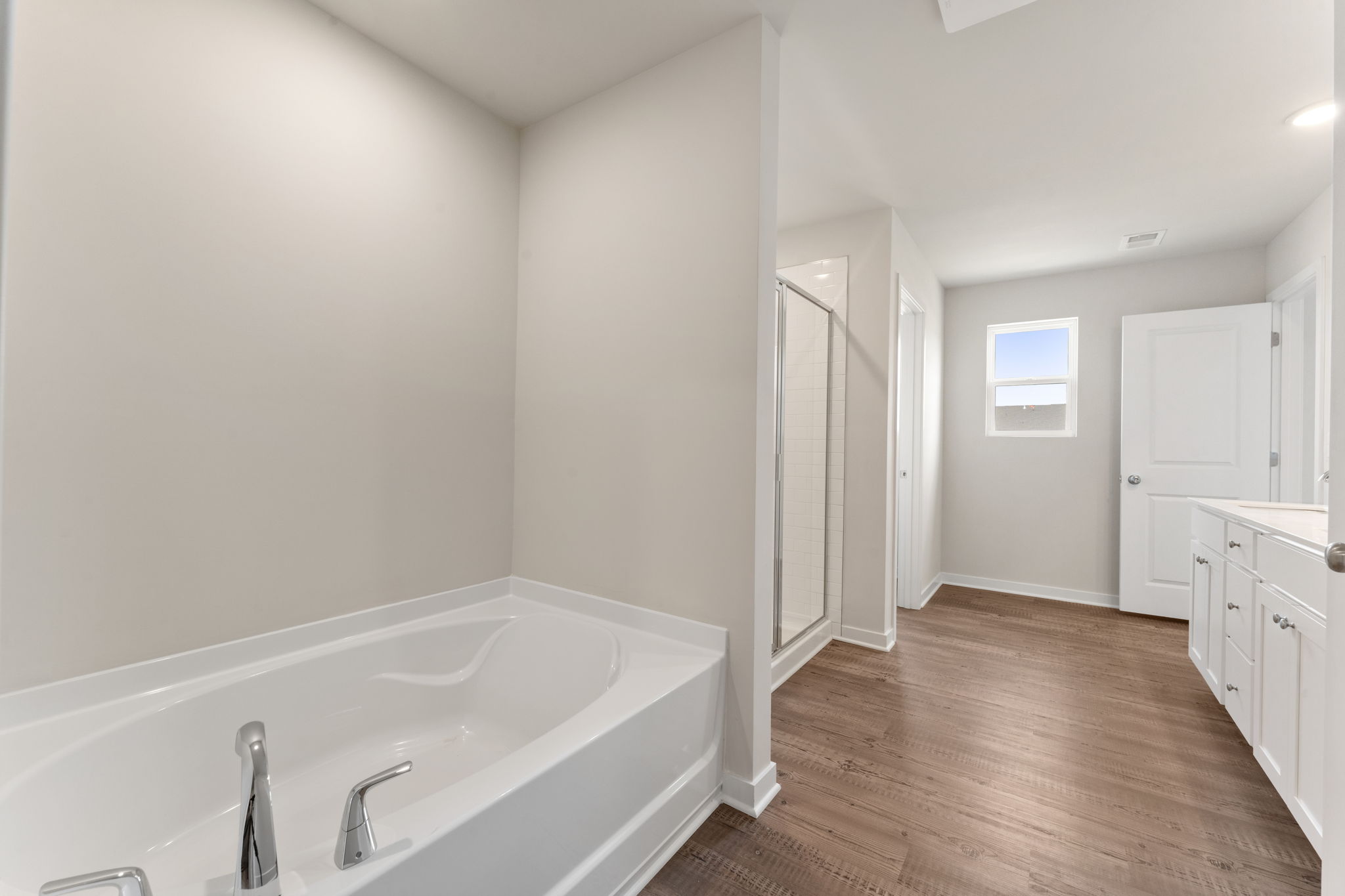 A bathroom with a tub and a shower.